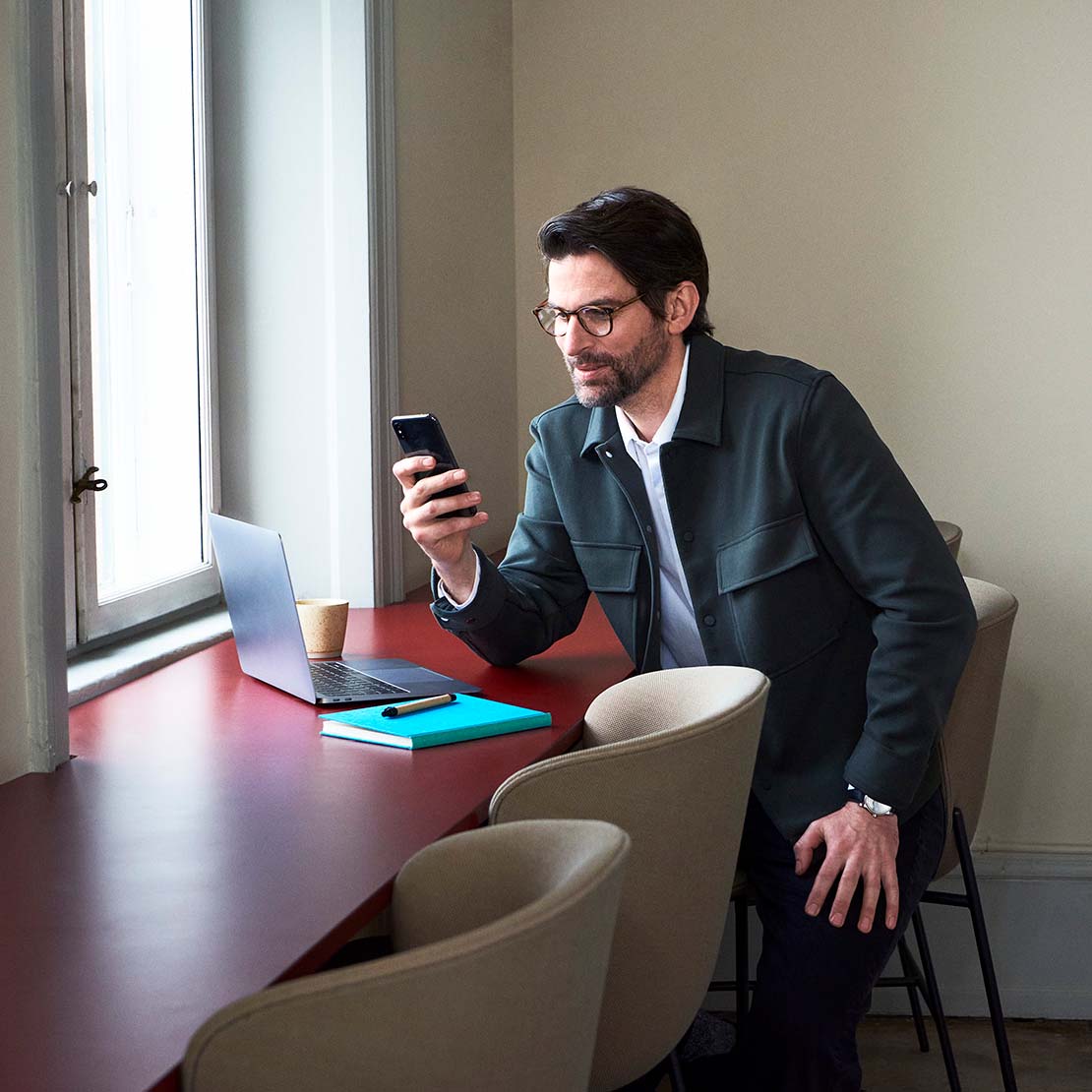 Image of a man looking at his phone.